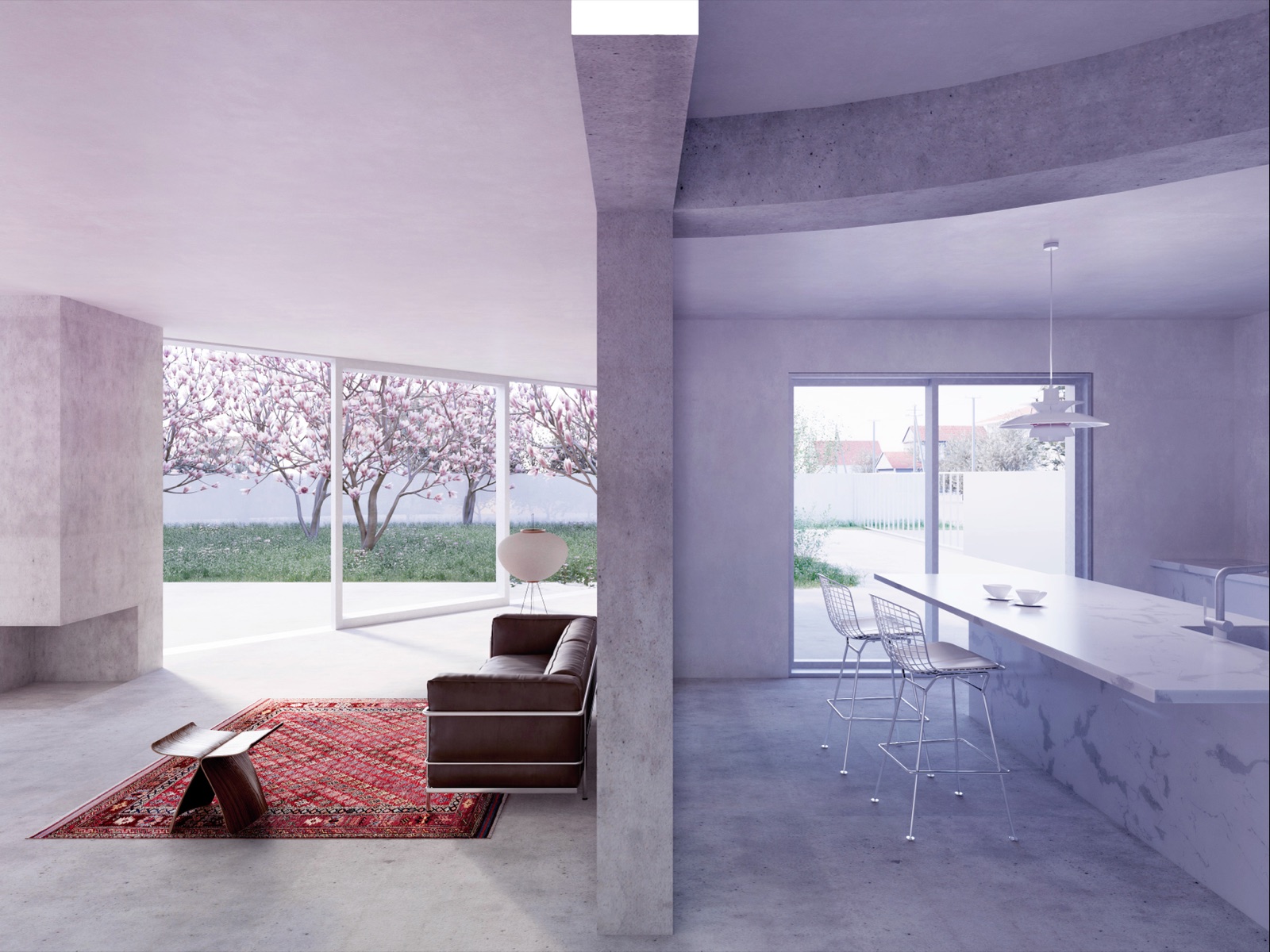 A worn red oriental rug on a bare concrete floor, a brown leather sofa beside it, and magnolias in bloom filling the window wall.